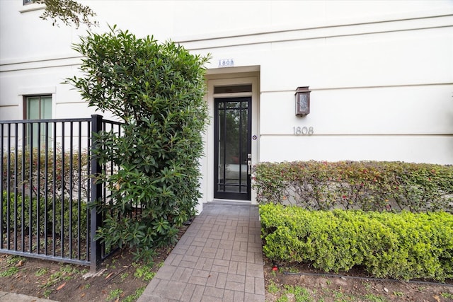 entrance to property featuring fence