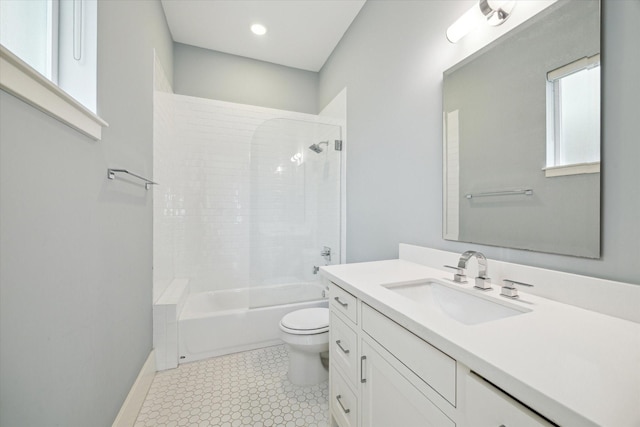 bathroom featuring baseboards, toilet, tile patterned floors, vanity, and washtub / shower combination