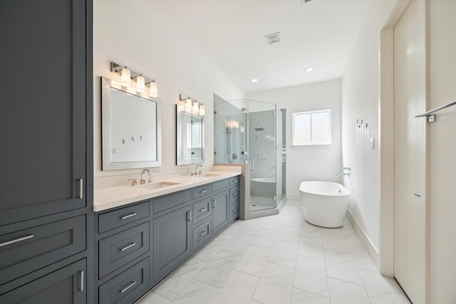 full bath featuring a stall shower, a soaking tub, marble finish floor, and a sink