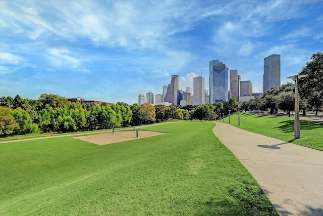 view of community with a view of city and a lawn