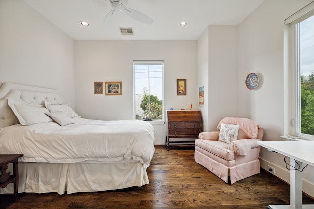 bedroom featuring dark wood-type flooring, multiple windows, and visible vents