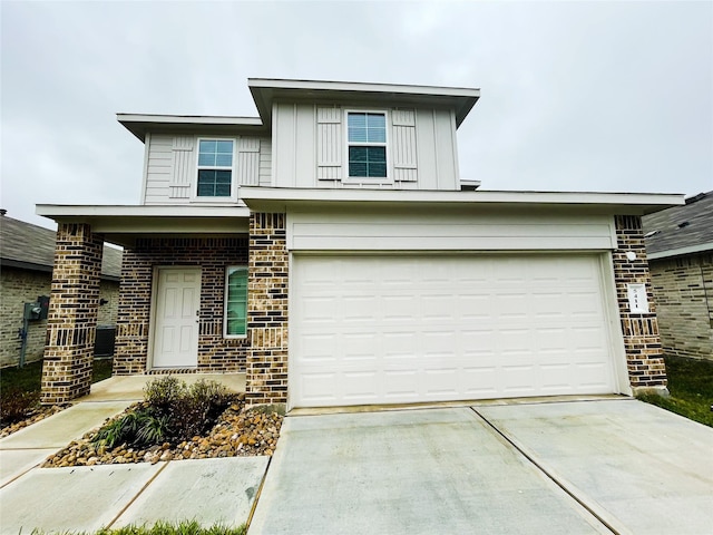 view of front of property with driveway, a garage, board and batten siding, and brick siding