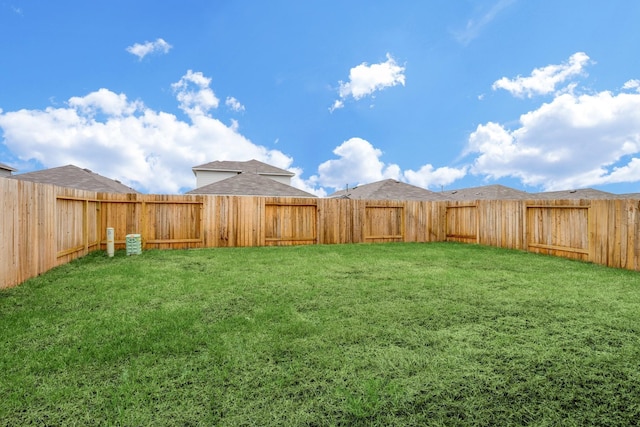 view of yard with a fenced backyard