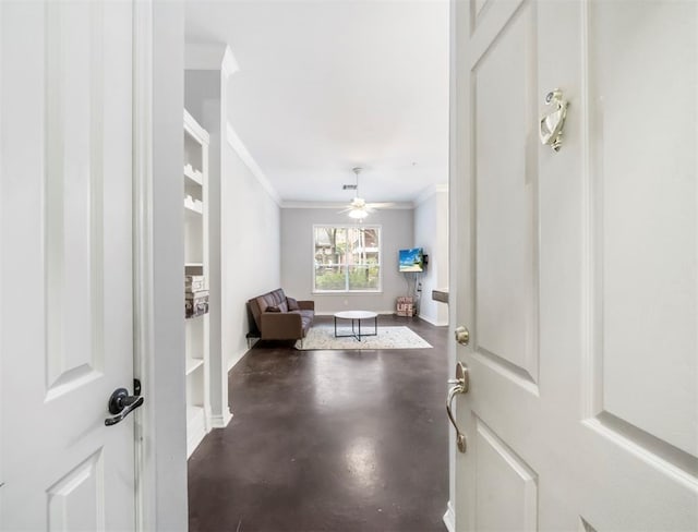 foyer with crown molding, concrete floors, baseboards, and ceiling fan