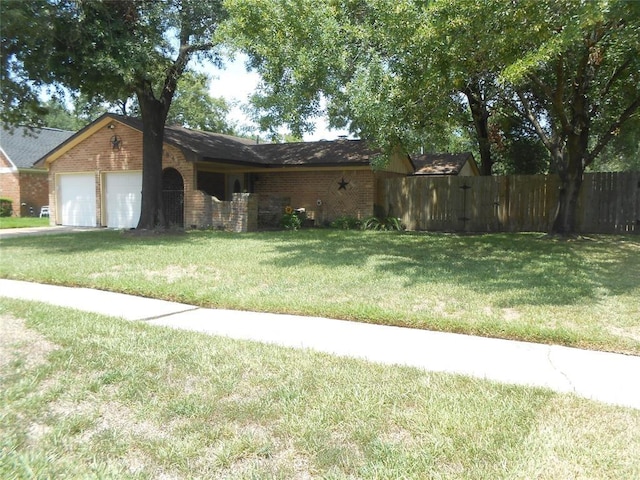 view of front of home with a garage, brick siding, a front lawn, and fence