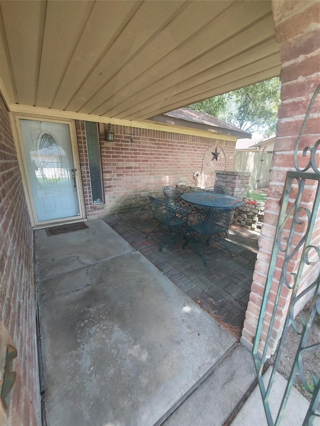 view of patio with outdoor dining space and fence