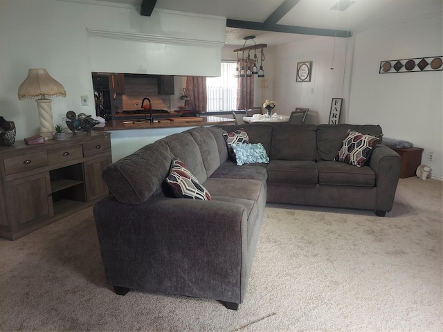 living room with beamed ceiling and carpet flooring