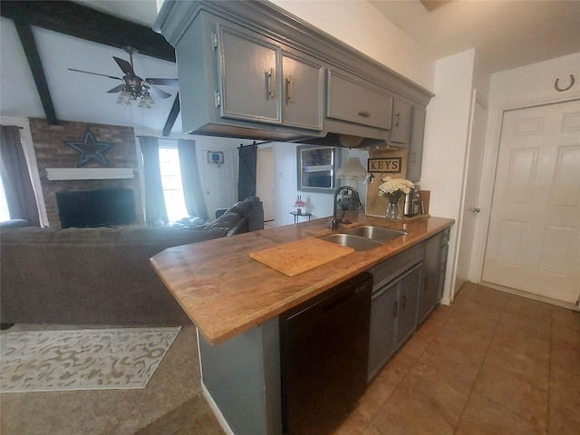 kitchen featuring ceiling fan, beamed ceiling, black dishwasher, light tile patterned floors, and a sink