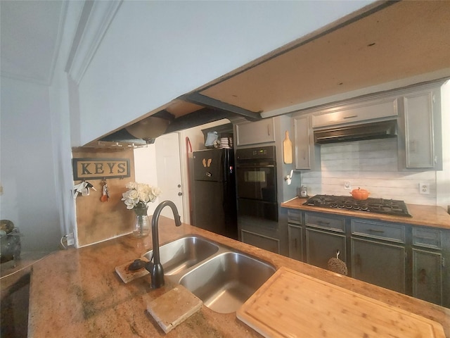 kitchen featuring a sink, tasteful backsplash, black appliances, and under cabinet range hood