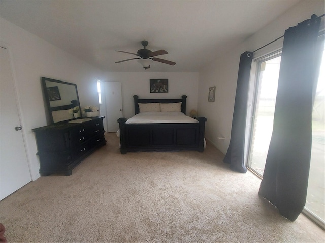 bedroom featuring light colored carpet and ceiling fan