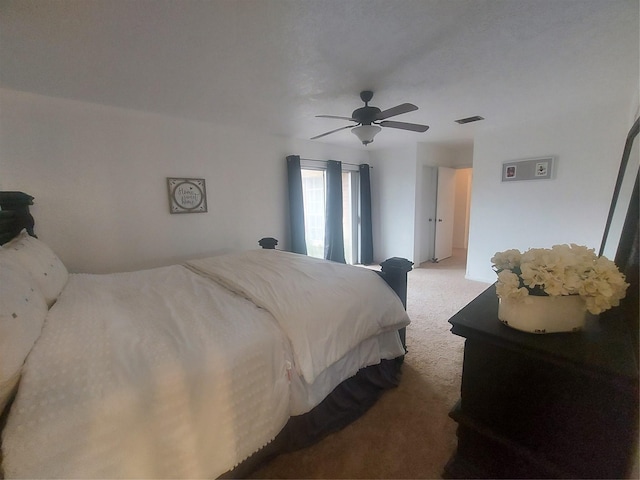 carpeted bedroom with visible vents and ceiling fan