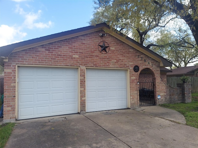 garage featuring concrete driveway