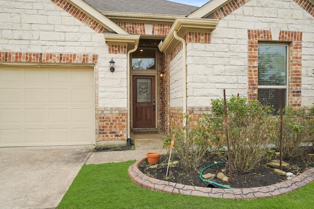 entrance to property with a garage, a shingled roof, and brick siding