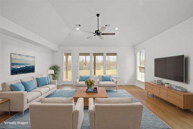 living area with light wood-style floors, recessed lighting, visible vents, and lofted ceiling