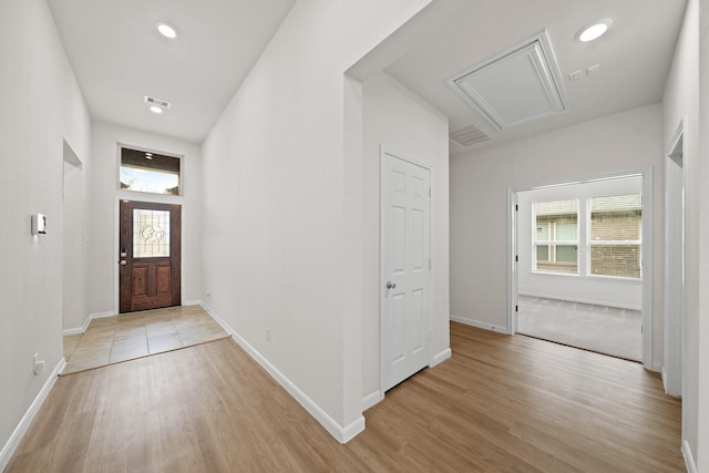 entryway featuring light wood-style floors, visible vents, baseboards, and recessed lighting