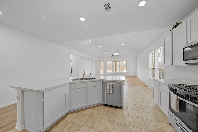 kitchen with light countertops, appliances with stainless steel finishes, visible vents, and white cabinets