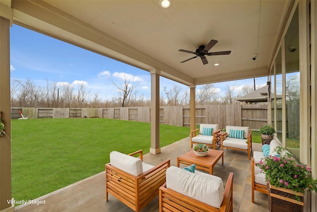 view of patio featuring a fenced backyard, an outdoor hangout area, and a ceiling fan