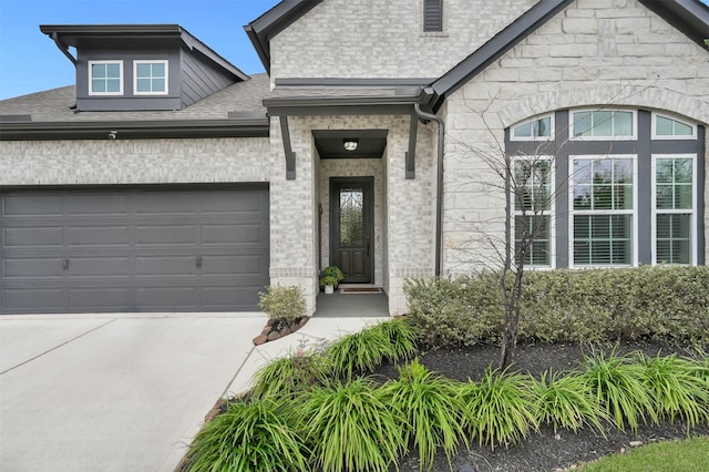 exterior space with driveway, a shingled roof, an attached garage, and brick siding