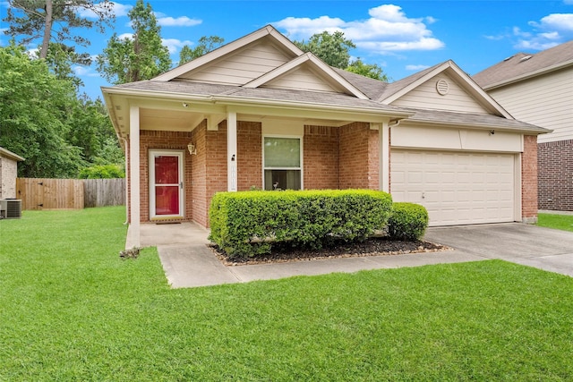 ranch-style home featuring an attached garage, brick siding, fence, driveway, and a front lawn