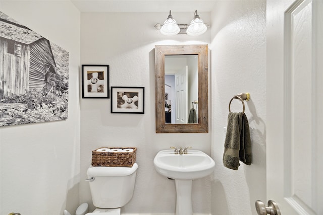 bathroom featuring toilet and a sink