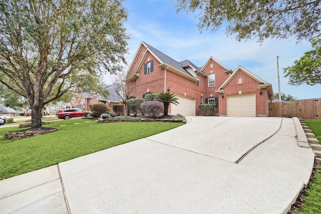 traditional-style home with driveway, brick siding, a front lawn, and fence