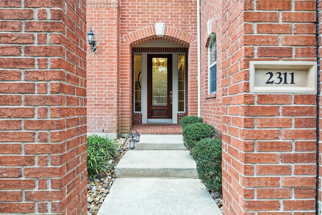 entrance to property with brick siding