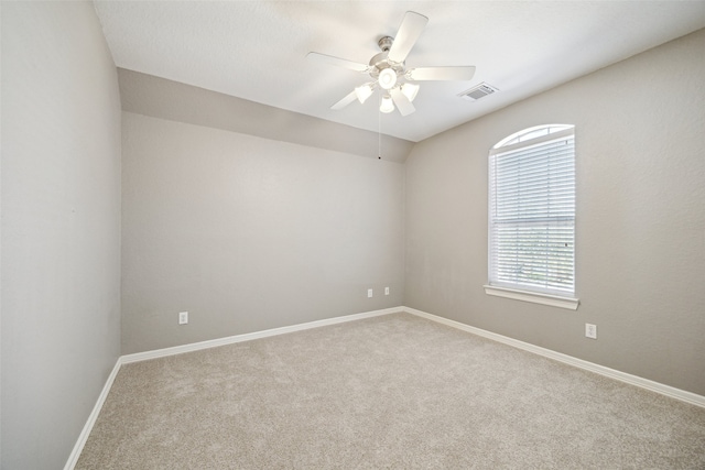 empty room with visible vents, baseboards, a ceiling fan, and carpet floors