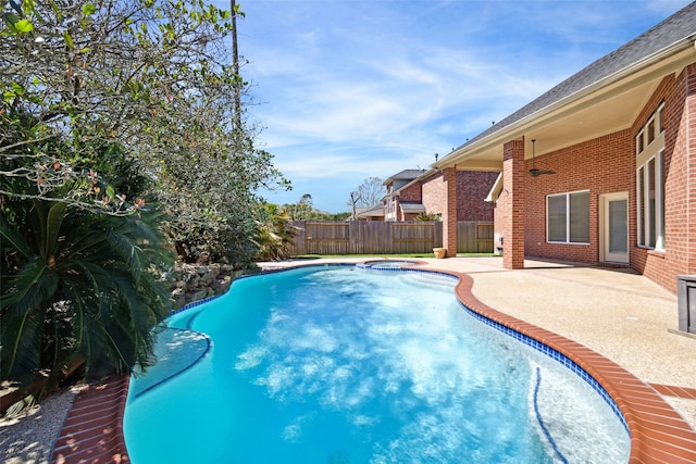 view of swimming pool with a fenced in pool, fence, an in ground hot tub, and a patio area