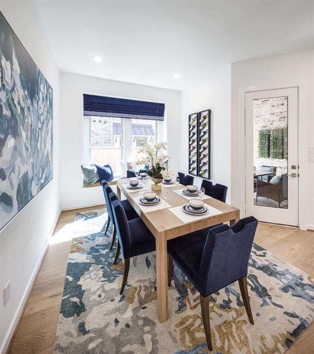 dining space featuring baseboards, recessed lighting, and light wood-style floors