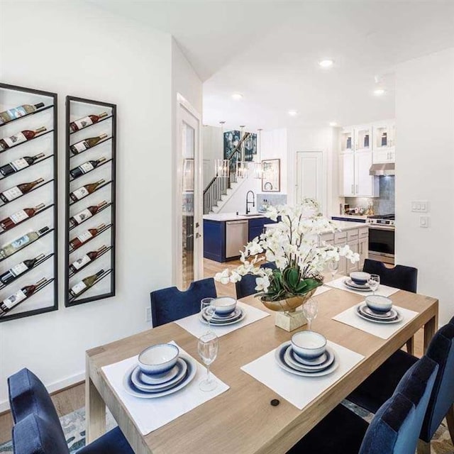 dining space featuring stairway and recessed lighting