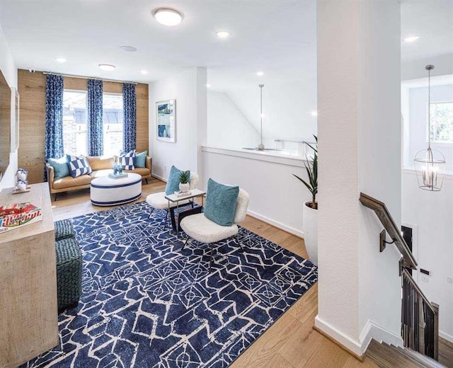 sitting room with plenty of natural light, baseboards, and wood finished floors