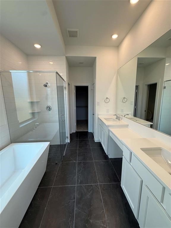 27015 Aurora Garden Ln, Katy, TX 77493 - bathroom with double vanity, a freestanding tub, a stall shower, and recessed lighting