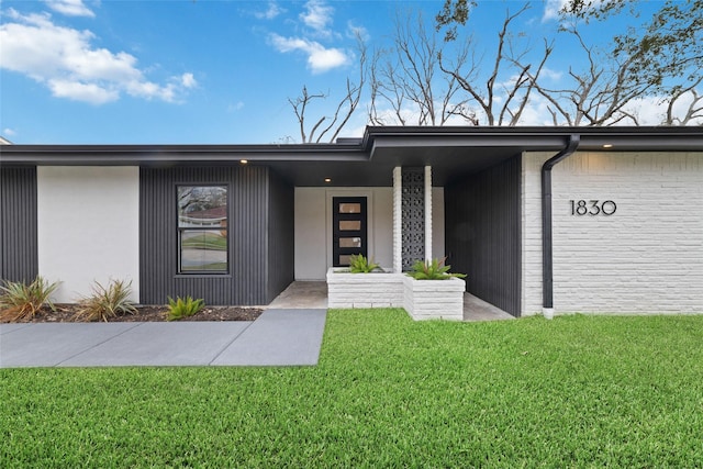 entrance to property with a yard