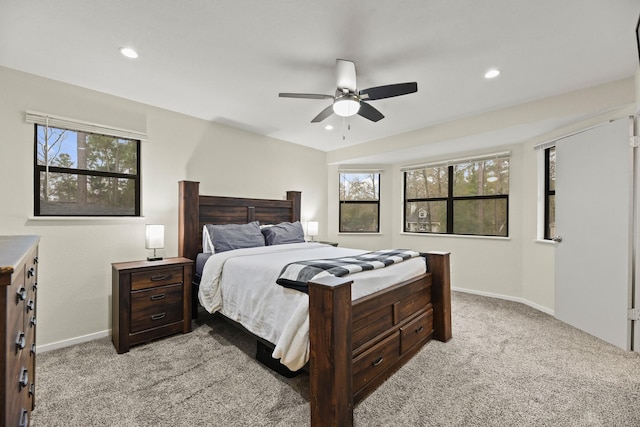 bedroom with light carpet, recessed lighting, and baseboards