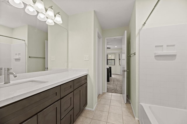 bathroom featuring shower / bath combination, vanity, a chandelier, baseboards, and tile patterned floors