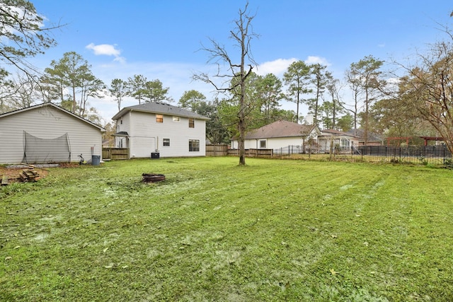 view of yard featuring a fenced backyard and a trampoline