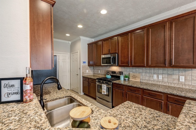 kitchen with stainless steel appliances, tasteful backsplash, a sink, and light stone counters