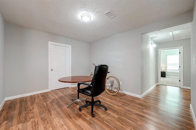 office with visible vents, baseboards, and wood finished floors