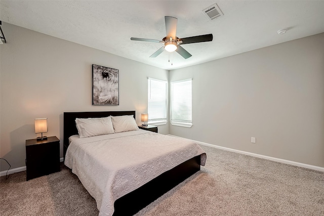 bedroom with carpet floors, visible vents, and baseboards