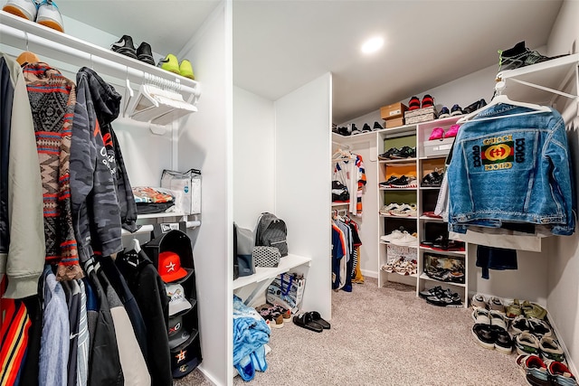 walk in closet featuring carpet floors