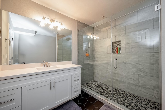 bathroom featuring a shower stall, vanity, and tile patterned floors