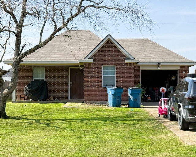 single story home featuring a front lawn, brick siding, and an attached garage