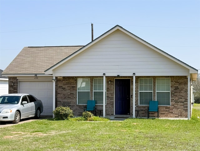 view of front of house featuring an attached garage, brick siding, a shingled roof, and a front yard