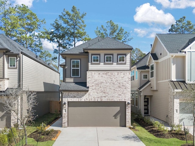 view of front of home with a garage, concrete driveway, and roof with shingles