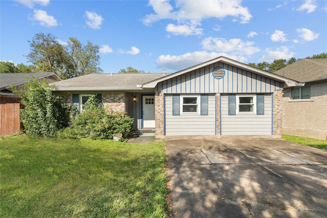 ranch-style house featuring driveway, fence, a front lawn, board and batten siding, and brick siding