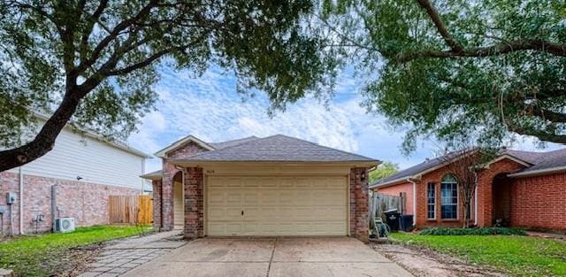 view of side of property with driveway, fence, and brick siding