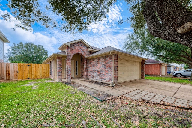 view of front of property featuring brick siding, concrete driveway, a front yard, fence, and a garage