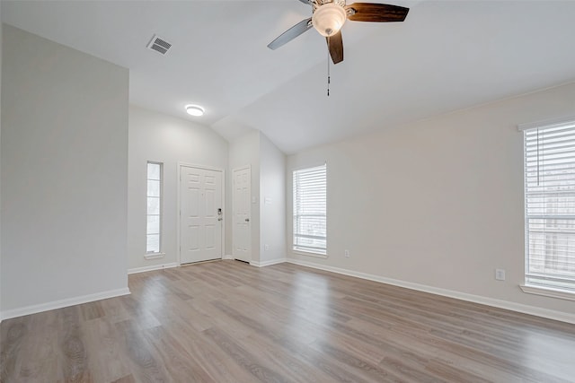 entrance foyer featuring lofted ceiling, a ceiling fan, visible vents, baseboards, and light wood-type flooring