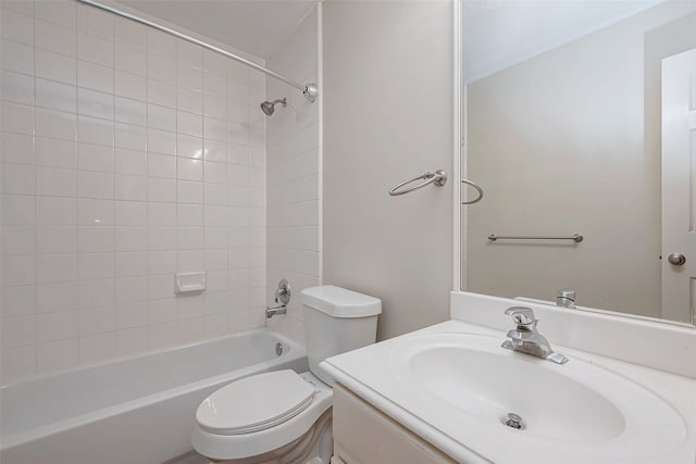 bathroom with washtub / shower combination, vanity, and toilet