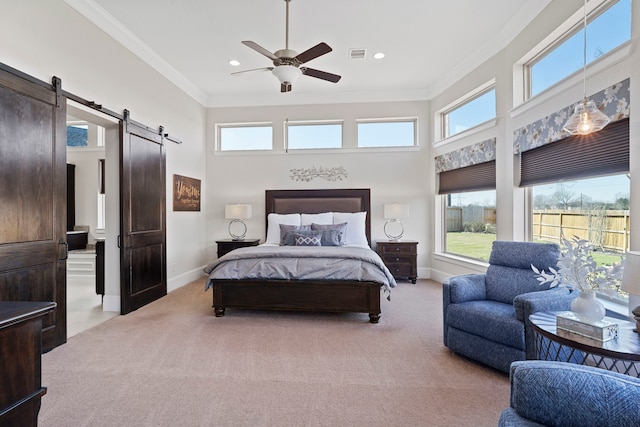 bedroom featuring ornamental molding, a barn door, carpet flooring, and visible vents